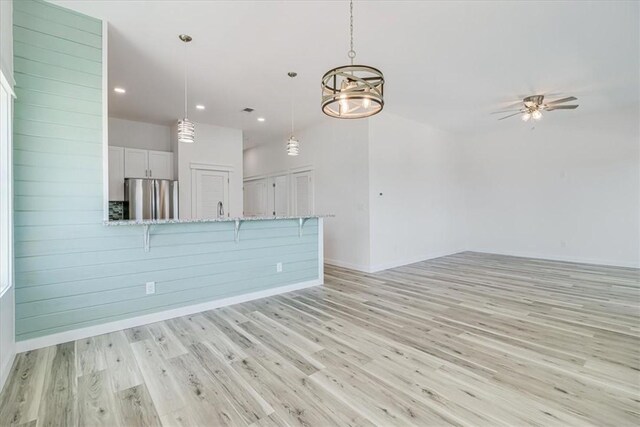 235 Port Mansfield St, Port Aransas, TX 78373 - unfurnished living room with light wood finished floors, recessed lighting, baseboards, and a ceiling fan