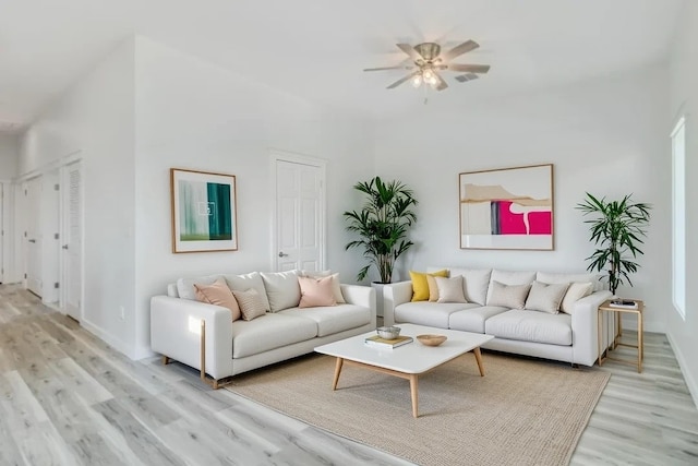 235 Port Mansfield St, Port Aransas, TX 78373 - living area with light wood finished floors, a ceiling fan, and baseboards