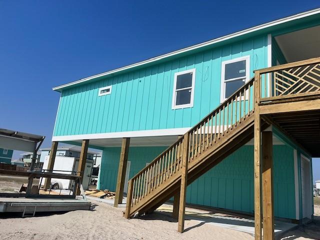 back of house featuring stairway