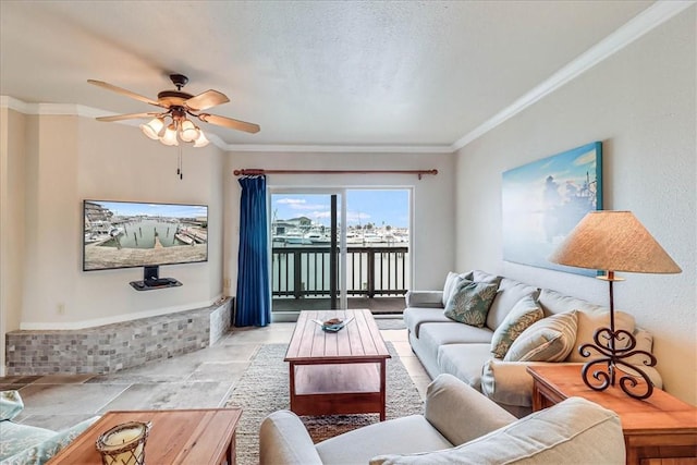 living room with ceiling fan, ornamental molding, and a textured ceiling