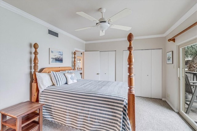 bedroom featuring multiple closets, access to exterior, visible vents, and crown molding