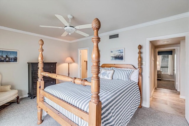 bedroom with light carpet, visible vents, and crown molding