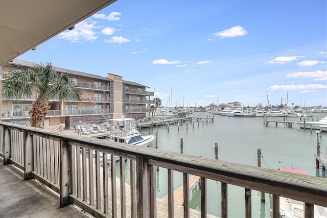 exterior space featuring a balcony and a water view