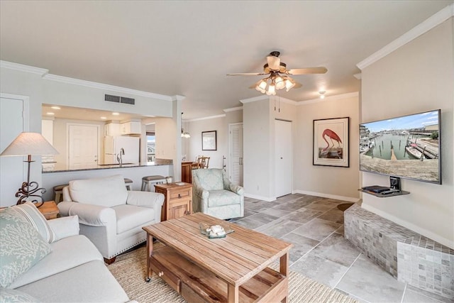 living room with crown molding, visible vents, ceiling fan, and baseboards