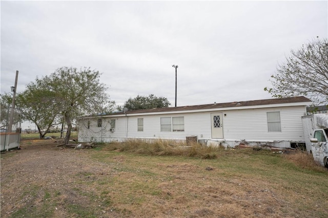 back of property featuring a lawn