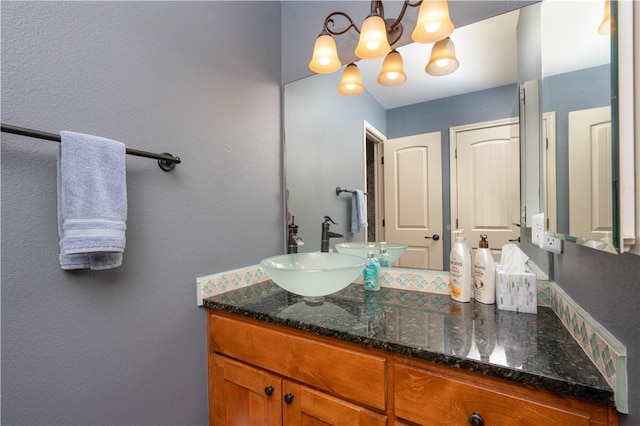 bathroom featuring a chandelier and vanity