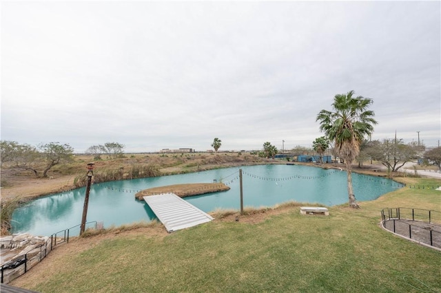 dock area featuring a lawn and a water view