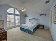 15230 Isabella Ct, Corpus Christi, TX 78418 - bedroom with vaulted ceiling, carpet, and a ceiling fan