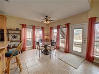 15230 Isabella Ct, Corpus Christi, TX 78418 - dining room with ceiling fan, plenty of natural light, and light tile patterned floors