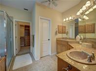 15230 Isabella Ct, Corpus Christi, TX 78418 - bathroom with a shower stall, vanity, and a ceiling fan