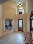 15230 Isabella Ct, Corpus Christi, TX 78418 - entryway featuring a towering ceiling, tile patterned flooring, and a chandelier