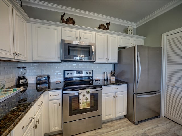 kitchen with white cabinets, light hardwood / wood-style floors, crown molding, and appliances with stainless steel finishes