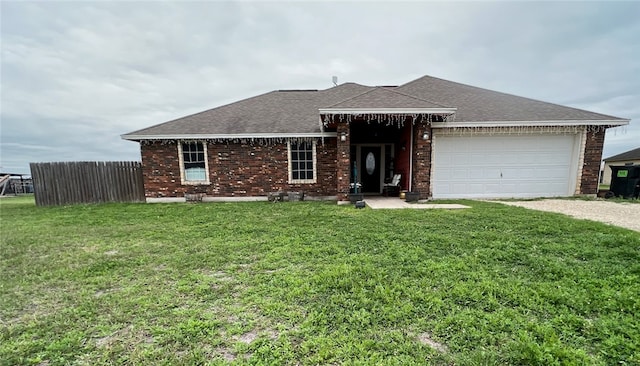 view of front of house featuring a garage and a front lawn