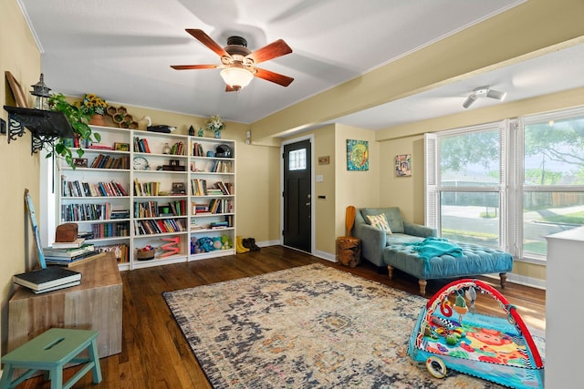 sitting room featuring ceiling fan and dark hardwood / wood-style floors