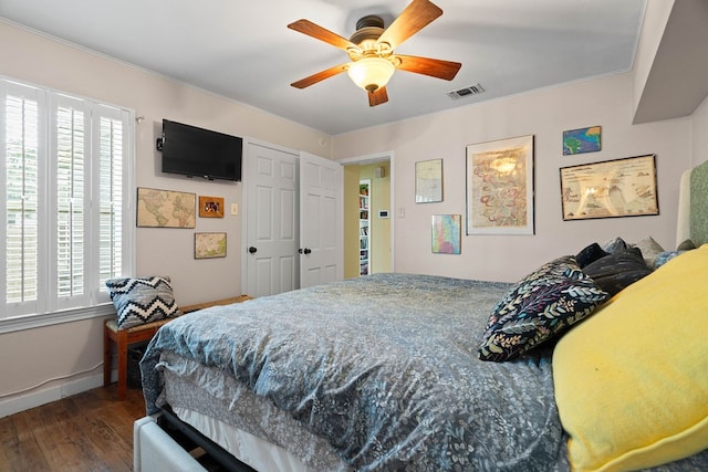 bedroom featuring ceiling fan and dark hardwood / wood-style floors