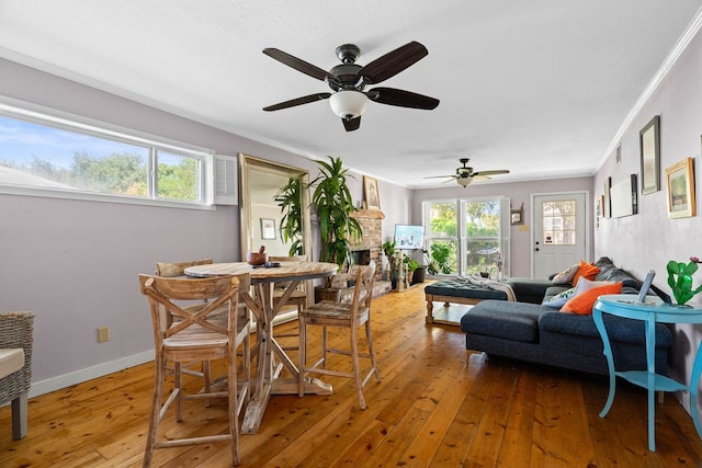 dining space with hardwood / wood-style floors, ceiling fan, and a healthy amount of sunlight