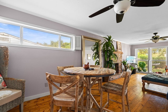 dining area with ceiling fan, dark hardwood / wood-style flooring, and ornamental molding