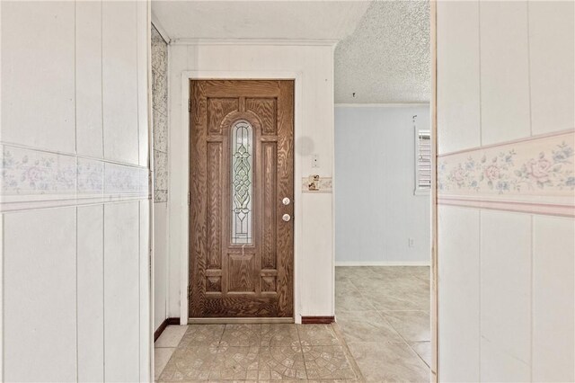 342 Davis Rd, Taft, TX 78390 - foyer entrance featuring crown molding, a textured ceiling, and light tile patterned floors