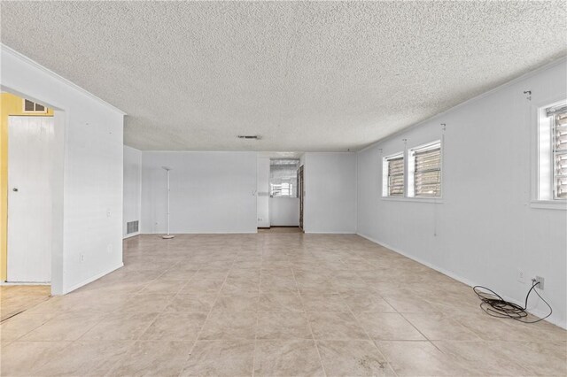 342 Davis Rd, Taft, TX 78390 - spare room with a textured ceiling and light tile patterned flooring
