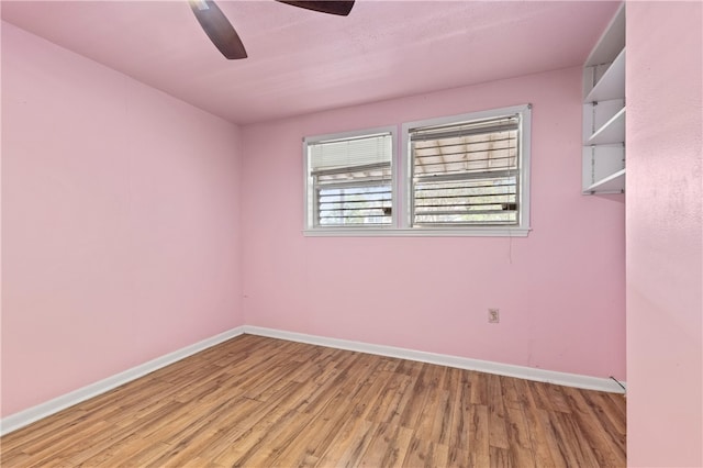 spare room featuring light hardwood / wood-style flooring and ceiling fan