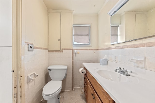 bathroom featuring tile walls, toilet, vanity, and tile patterned floors