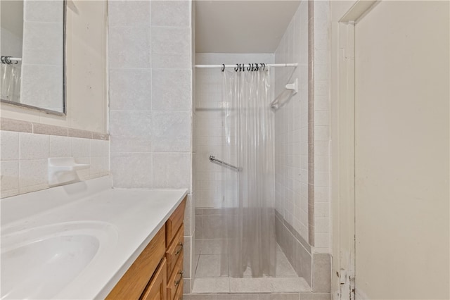 bathroom with a shower with curtain, vanity, and tile walls