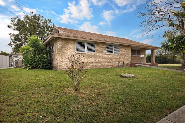 342 Davis Rd, Taft, TX 78390 - view of property exterior featuring brick siding and a lawn