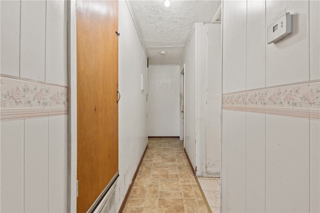 hallway with a textured ceiling