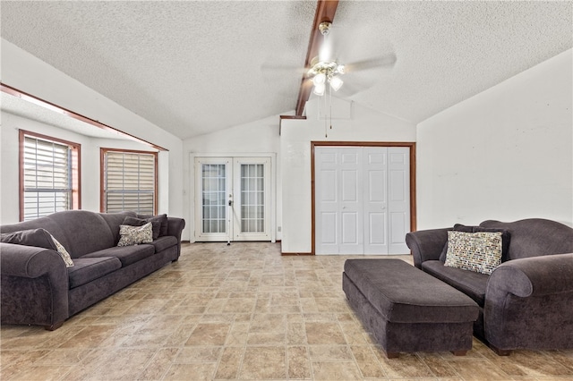 living room with a textured ceiling, french doors, ceiling fan, and vaulted ceiling