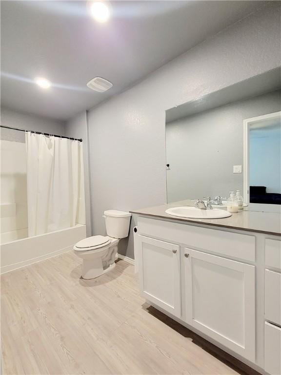 full bathroom featuring shower / bathtub combination with curtain, vanity, toilet, and wood-type flooring