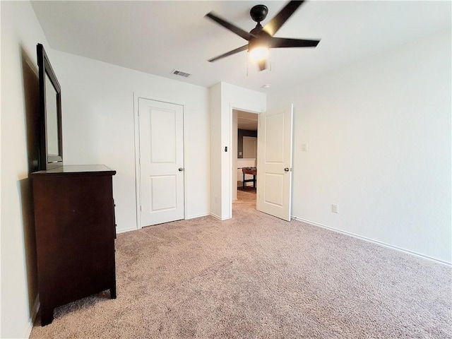 unfurnished bedroom featuring ceiling fan and light colored carpet