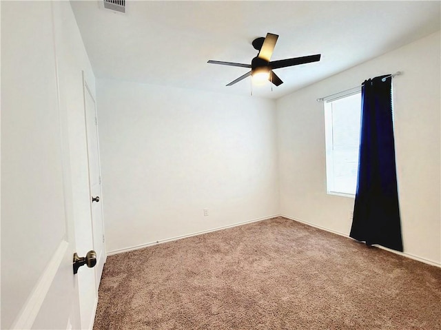 unfurnished room featuring ceiling fan and carpet floors