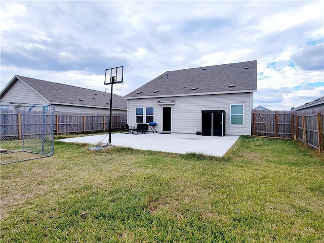 back of house with a lawn and a patio