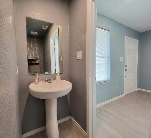 bathroom with hardwood / wood-style floors and sink