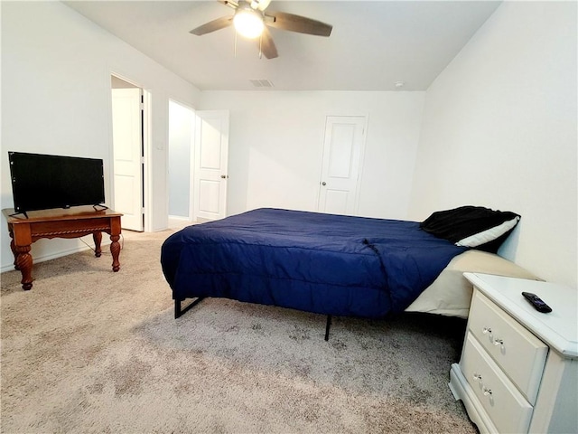 bedroom with ceiling fan and light colored carpet