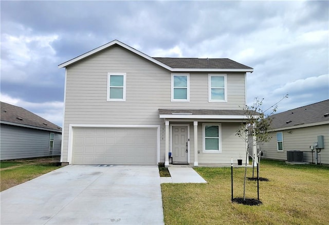 front facade with a front lawn, central AC unit, and a garage