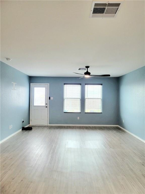 spare room with light wood-type flooring and ceiling fan