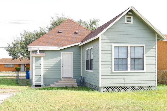 back of property featuring entry steps, a shingled roof, a lawn, crawl space, and fence