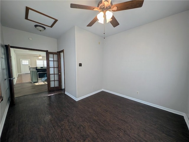 empty room featuring french doors, dark wood-type flooring, and baseboards