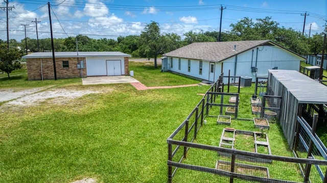 view of yard featuring an outbuilding and central AC