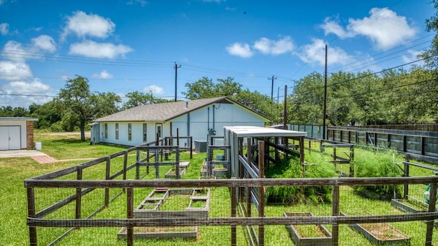 exterior space with an outbuilding, cooling unit, and a yard