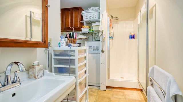 bathroom with a shower, tile patterned flooring, and sink