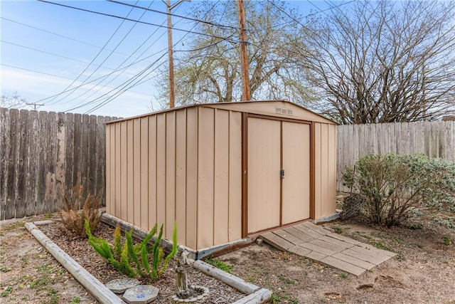 view of shed with a fenced backyard