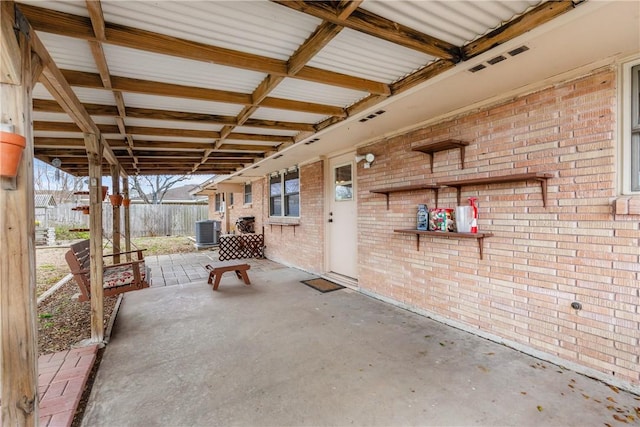 view of patio featuring cooling unit and fence