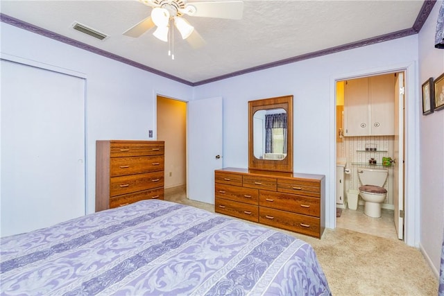 bedroom with visible vents, a closet, light carpet, crown molding, and connected bathroom