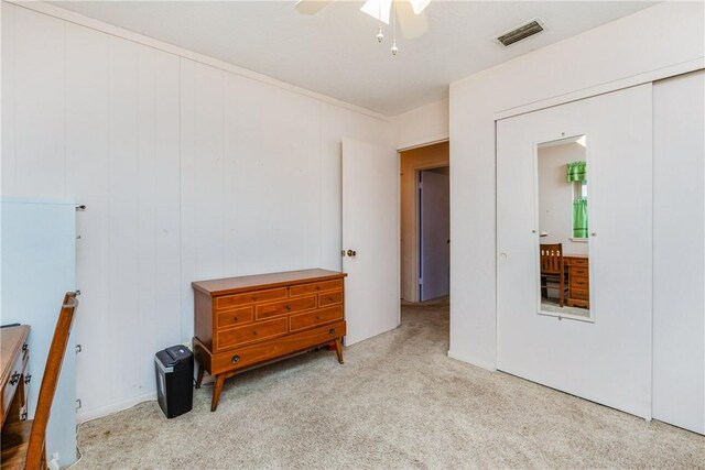 bedroom featuring a ceiling fan, carpet, and visible vents