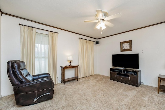 sitting room featuring ceiling fan, carpet, and ornamental molding