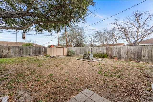 view of yard with a fenced backyard, a shed, and an outdoor structure