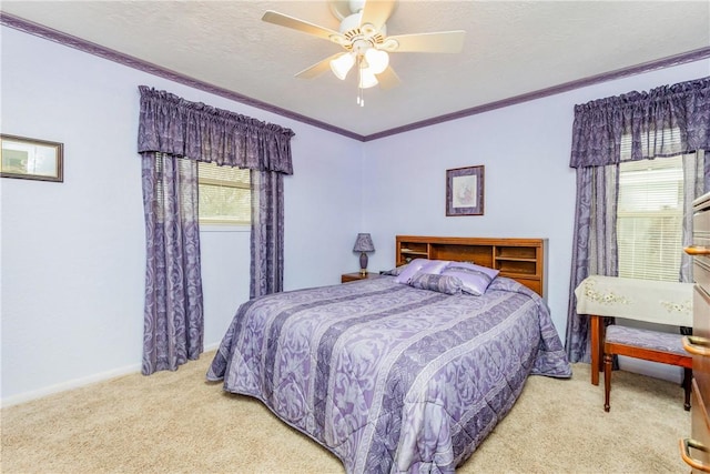 carpeted bedroom featuring baseboards, a textured ceiling, ornamental molding, and a ceiling fan