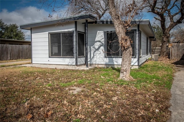 view of side of home with a lawn